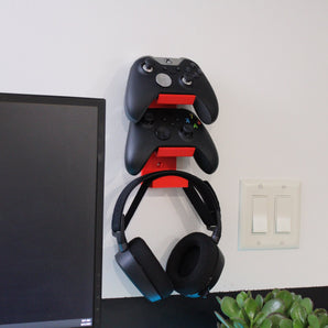 Soporte de pared práctico para dos mandos y auriculares