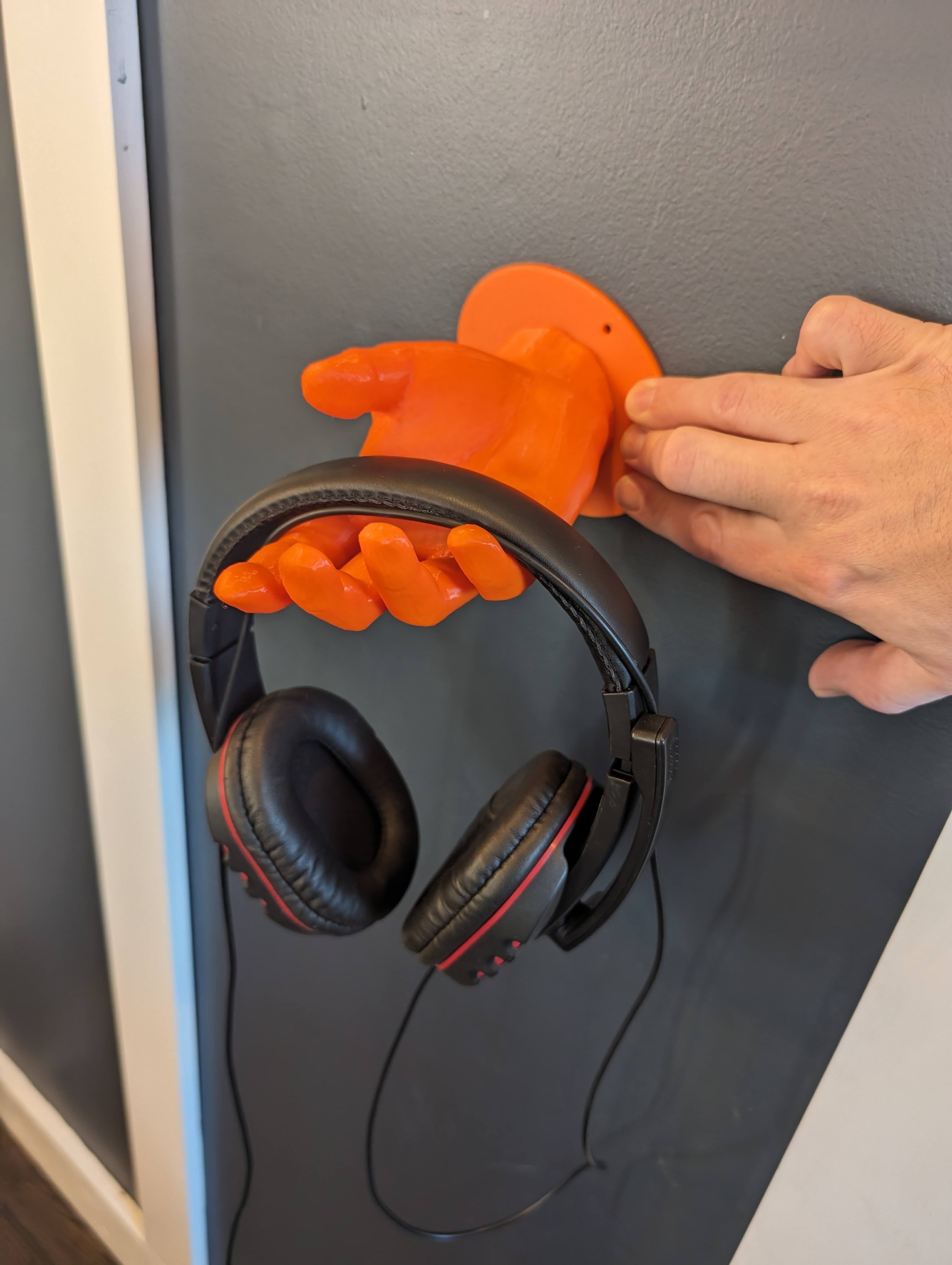 Soporte para auriculares en forma de mano montado en la pared
