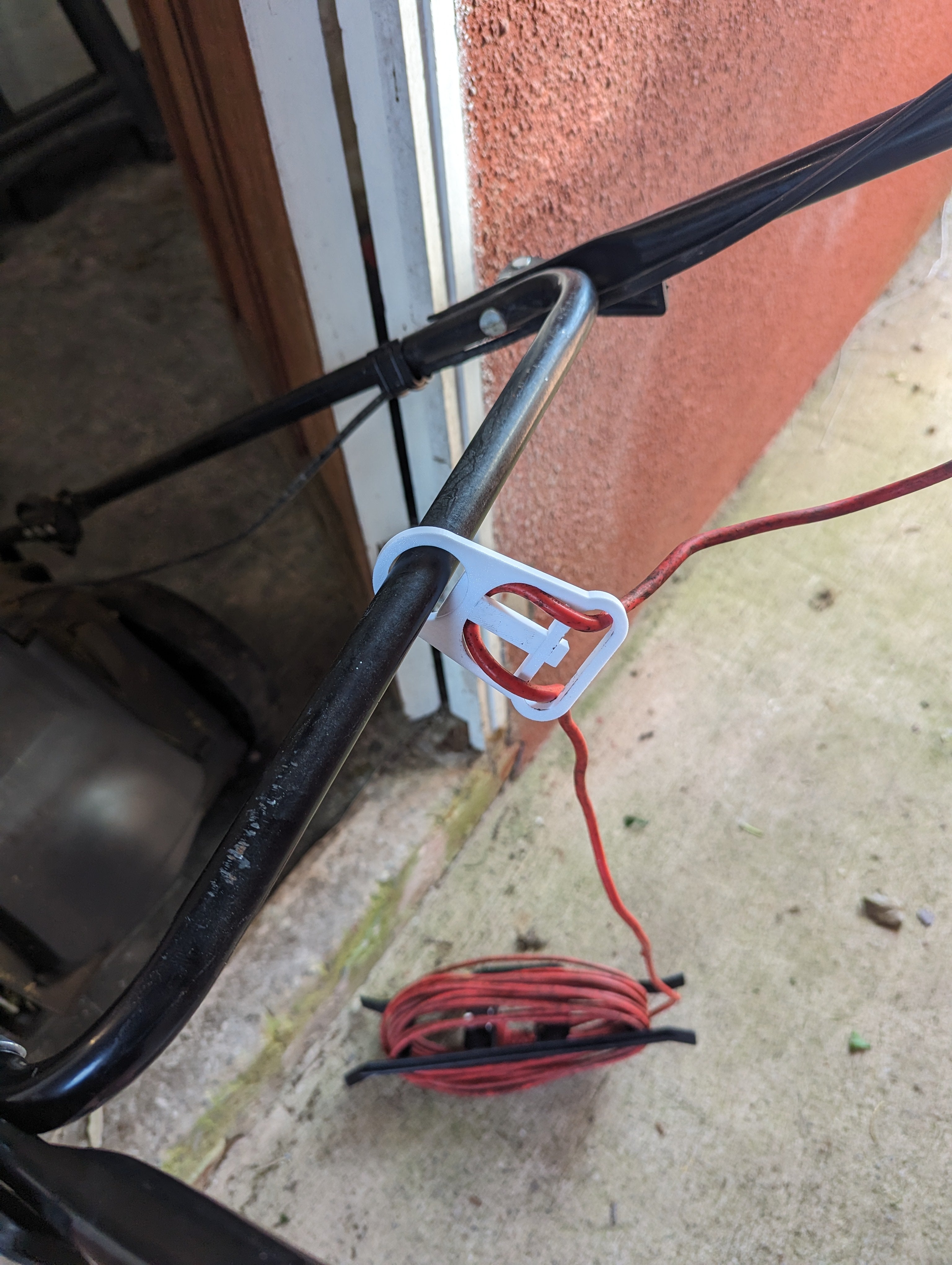 Soporte de cable para cortacésped eléctrico