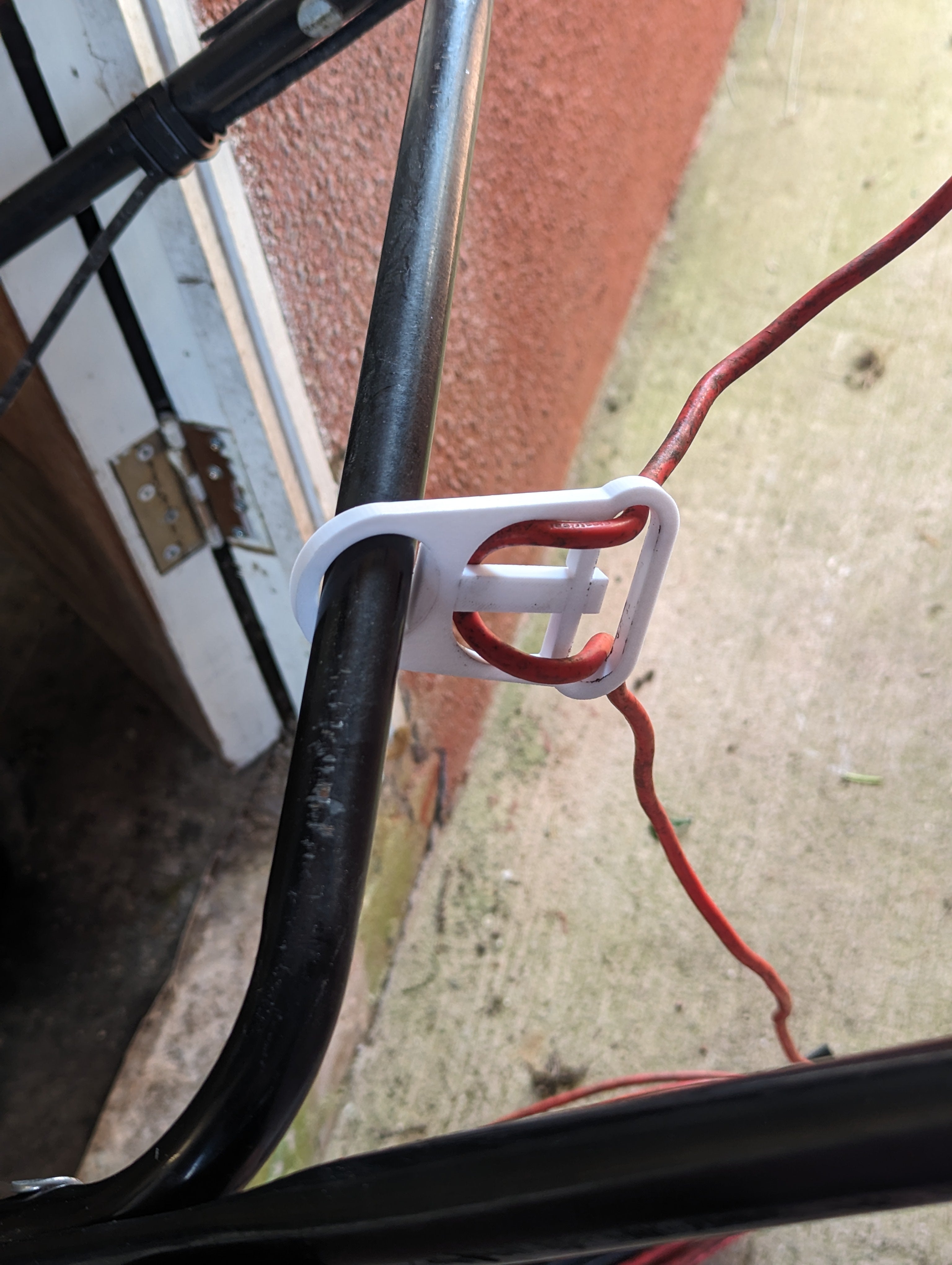 Soporte de cable para cortacésped eléctrico