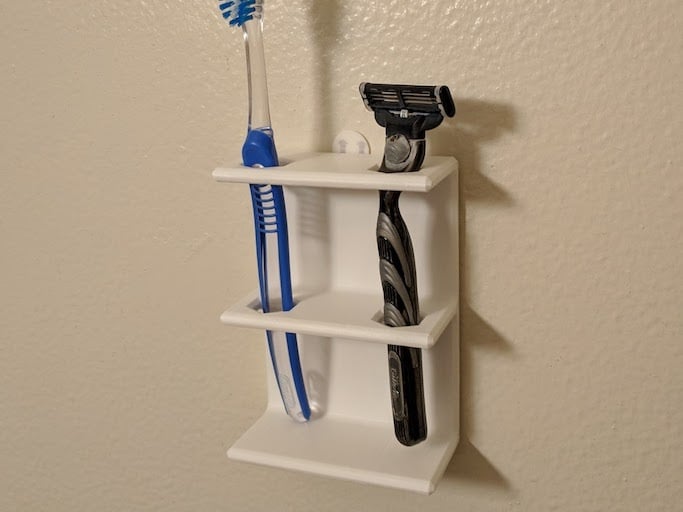 Soporte de pared para cepillo de dientes o afeitadora