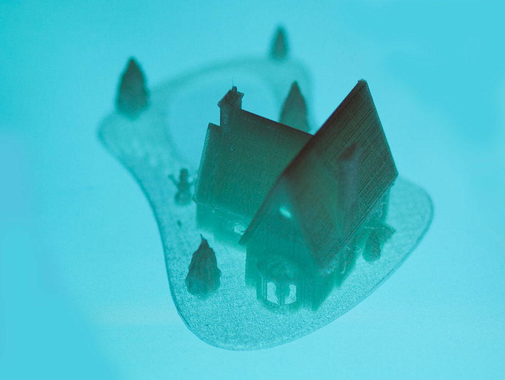 Casa navideña impresa en 3D con lago helado