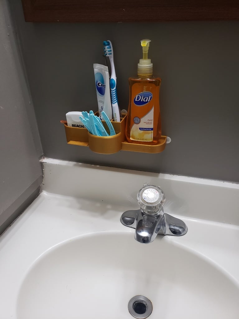 Organizador de baño con jabonera y porta cepillos de dientes.