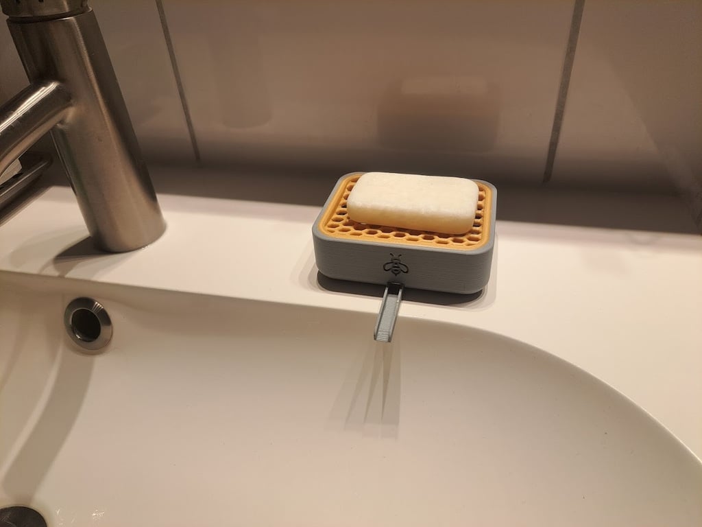 Dispensador de jabón con desagüe para baño.
